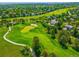 Aerial view of a golf course and the surrounding neighborhood at 7332 Woodglen Pl, Castle Pines, CO 80108
