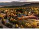 Aerial view of a brown home surrounded by green forest at 7332 Woodglen Pl, Castle Pines, CO 80108