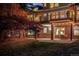 Backyard at dusk with a patio, lawn, and string lights at 7332 Woodglen Pl, Castle Pines, CO 80108