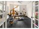 Home gym featuring workout equipment, rubber floor and Superman decor at 7332 Woodglen Pl, Castle Pines, CO 80108