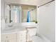 Bright bathroom with tile flooring, white fixtures, and vanity with ample storage space at 7332 Woodglen Pl, Castle Pines, CO 80108