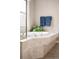 A luxurious soaking tub with elegant fixtures and neutral tile surround, perfect for relaxation at 7332 Woodglen Pl, Castle Pines, CO 80108