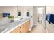 Bright bathroom featuring double sinks, white tile counters, and view into a toilet and shower room at 7332 Woodglen Pl, Castle Pines, CO 80108