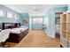 Comfortable blue bedroom with natural light and an attached bathroom, perfect for rest and relaxation at 7332 Woodglen Pl, Castle Pines, CO 80108