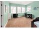 Bright bedroom with carpeted flooring, three windows, and a desk for work or study at 7332 Woodglen Pl, Castle Pines, CO 80108