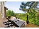 Outdoor deck featuring patio furniture, including lounge chairs, and a scenic wooded view at 7332 Woodglen Pl, Castle Pines, CO 80108