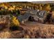 Aerial view of a well-maintained home featuring an attached garage and lush landscaping at 7332 Woodglen Pl, Castle Pines, CO 80108