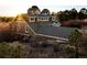 View of the rear of a house with a dark roof and light-colored siding at 7332 Woodglen Pl, Castle Pines, CO 80108