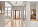 Inviting foyer with hardwood floors, decorative front door, and views into living spaces at 7332 Woodglen Pl, Castle Pines, CO 80108