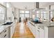 Gourmet kitchen featuring granite countertops, an island cooktop, and a built-in dining area at 7332 Woodglen Pl, Castle Pines, CO 80108