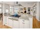 Open kitchen with granite countertops, a stainless steel range hood, and adjacent living spaces at 7332 Woodglen Pl, Castle Pines, CO 80108