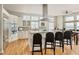 Spacious kitchen with stainless appliances, granite countertops, and large center island with seating at 7332 Woodglen Pl, Castle Pines, CO 80108