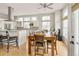 Bright kitchen with stainless steel appliances, center island, and adjacent wooden dining table and seating at 7332 Woodglen Pl, Castle Pines, CO 80108