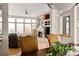 Inviting living room with a fireplace, built-in shelves, and large windows at 7332 Woodglen Pl, Castle Pines, CO 80108