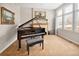 Elegant living room featuring a grand piano, fireplace, and an abundance of natural light from the large windows at 7332 Woodglen Pl, Castle Pines, CO 80108