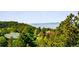 Idyllic view showcasing a home surrounded by mature trees; mountain views in the distance at 7332 Woodglen Pl, Castle Pines, CO 80108