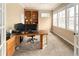 Bright office space with built in shelving, a large desk and multiple windows at 7332 Woodglen Pl, Castle Pines, CO 80108