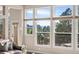 Bright sunroom with many windows showcasing outdoor views and comfortable seating at 7332 Woodglen Pl, Castle Pines, CO 80108