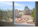 A nature view as seen through a home's window at 7332 Woodglen Pl, Castle Pines, CO 80108