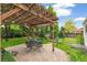 Relaxing backyard patio with a pergola covering a dining set and a fire pit at 4285 Newland St, Wheat Ridge, CO 80033