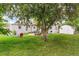 Spacious backyard featuring a patio with a pergola, fire pit, grill and storage shed at 4285 Newland St, Wheat Ridge, CO 80033