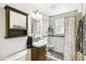 Updated bathroom featuring modern vanity, decorative tile, and a tiled shower at 4285 Newland St, Wheat Ridge, CO 80033