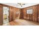 Bedroom featuring classic wood-paneled walls and bright, natural light at 4285 Newland St, Wheat Ridge, CO 80033