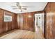 Inviting bedroom with wood paneling, hardwood floors, and natural light at 4285 Newland St, Wheat Ridge, CO 80033
