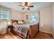 This bright bedroom features hardwood floors, a ceiling fan, and a cozy bed at 4285 Newland St, Wheat Ridge, CO 80033
