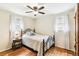 Comfortable bedroom with hardwood floors, decorative lamp, and sheer curtains at 4285 Newland St, Wheat Ridge, CO 80033