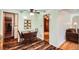 Charming dining area featuring hardwood floors, a table with chairs, and access to other rooms at 4285 Newland St, Wheat Ridge, CO 80033