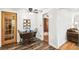 Charming dining room with wood floors, seating for four, and decorative glass door at 4285 Newland St, Wheat Ridge, CO 80033