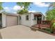 Welcoming home featuring an attached garage, front porch, and tidy landscaping at 4285 Newland St, Wheat Ridge, CO 80033