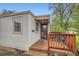 Inviting front porch with wood railing and stained wood ceiling, showcasing the home's exterior details at 4285 Newland St, Wheat Ridge, CO 80033