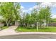 Charming home with a well-maintained front yard, mature trees, and a welcoming entrance at 4285 Newland St, Wheat Ridge, CO 80033