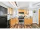 Cozy kitchen featuring wooden cabinets, stainless steel appliances, and a bright skylight at 4285 Newland St, Wheat Ridge, CO 80033