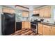 This bright kitchen boasts wood cabinets, a gas range, and stainless steel appliances at 4285 Newland St, Wheat Ridge, CO 80033