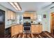 A sunlit kitchen featuring wood cabinets, a gas range, and stainless steel appliances at 4285 Newland St, Wheat Ridge, CO 80033
