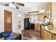 Functional kitchen featuring wood cabinets, appliances, and a cozy dining area at 4285 Newland St, Wheat Ridge, CO 80033