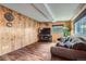 Inviting living room featuring wood paneled walls and comfortable seating at 4285 Newland St, Wheat Ridge, CO 80033