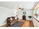 Cozy living room featuring hardwood floors, a bay window, and a comfortable sofa at 4285 Newland St, Wheat Ridge, CO 80033