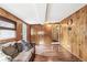 Spacious living room with wood-paneled walls and cozy seating area at 4285 Newland St, Wheat Ridge, CO 80033
