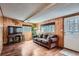 Cozy living room features wood paneled walls and lots of natural light at 4285 Newland St, Wheat Ridge, CO 80033