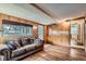 Wood paneled living room featuring comfortable seating and lots of natural light at 4285 Newland St, Wheat Ridge, CO 80033