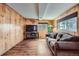 Cozy living room featuring wood paneled walls and comfortable seating at 4285 Newland St, Wheat Ridge, CO 80033