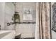 This bathroom features modern gray tiling, and mosaic floor in the shower area at 4285 Newland St, Wheat Ridge, CO 80033