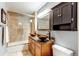 Updated bathroom with double vanity, glass enclosed shower, and a built-in cabinet at 2020 Arapahoe St # 1070, Denver, CO 80205