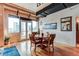 Dining area with round wooden table and chairs, offering city views from large windows at 2020 Arapahoe St # 1070, Denver, CO 80205