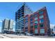 Full exterior view of modern condo building with brick and glass exterior at 2020 Arapahoe St # 1070, Denver, CO 80205