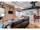 Spacious living room with sectional sofa, hardwood floors, and large windows with city views at 2020 Arapahoe St # 1070, Denver, CO 80205